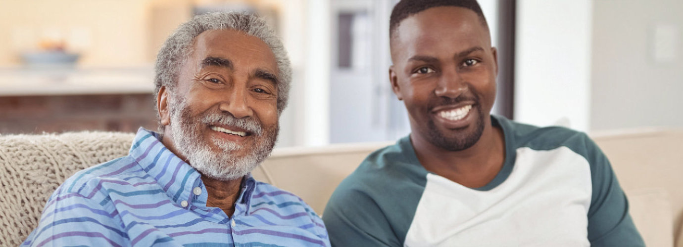 senior man and caregiver smiling